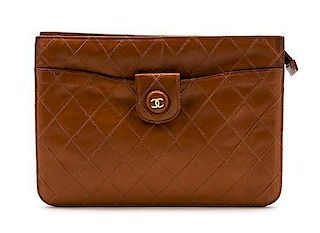 * A Chanel Cognac Quilted Leather Clutch, 10 x 7 1/2 x 1 1/2 inches.