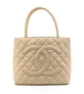 A Chanel Ivory Quilted Leather Medallion Tote Bag. 11 1/2 x 10 x 6 inches.