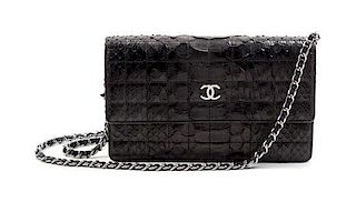 * A Chanel Black Python Leather Wallet on a Chain, 8 x 4 1/2 x 1 1/2 inches.