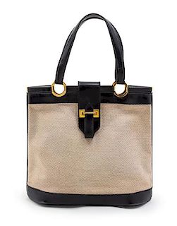 * An Hermes Black Leather and Ivory Canvas Bag, 12 x 10 1/2 x 4 1/2 inches.