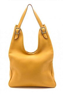 * An Hermes Gold Leather Massai Bag, 17 1/2 x 10 x 2 1/2 inches.