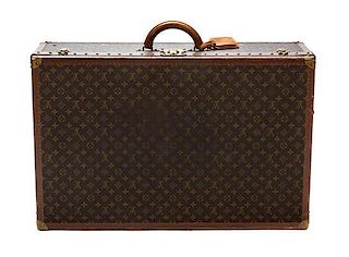 * A Louis Vuitton Monogram Canvas Hard-sided Suitcase, 31 1/2 x 20 x 10 inches.