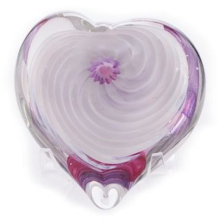 A blown glass heart on stand.