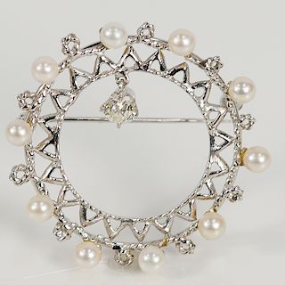 14 karat circular pin set with pearls and dangle diamonds.  4.5mm across top, 7.7 grams