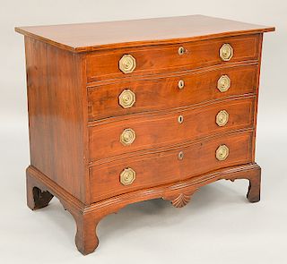 Mahogany serpentine front Chippendale chest having serpentine overhanging top over four graduated drawers with carved drop center, set on high b...