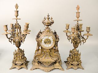Tiffany & Co. bronze and brass three piece mantle clock and candelabra garniture set, Rococo influenced with lion handles on sides,...