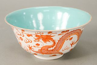 Dragon bowl, China, 20th century, decorated with orange, five-clawed dragon on a white body of incised clouds/waves, the sides risin...