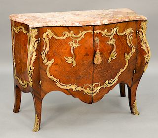 Louis XV style commode having shaped marble top over conforming case with two inlaid doors in brass mounts, early 20th century.  h...