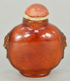 Amber snuff bottle having lion mask fixed rings.  ht. 1 3/4 in.