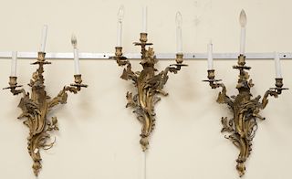 Set of eight French Rococo style bronze three light sconces.  ht. 24 in., wd. 14 in.  Provenance: From an estate in Lloyd Harbor...