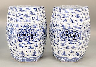 Pair of blue and white, hexagonal garden stools, China, 20th century, probably Republic Period, decorated with dragons amidst clouds...