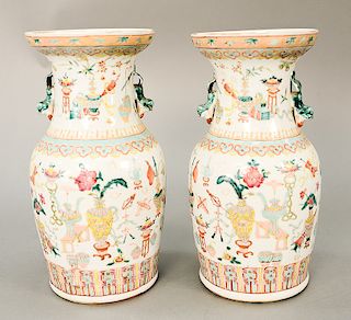 Pair of Famille Rose vases decorated with Buddhist symbols and vases with small foo lion handles.  ht. 13 in.