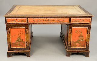 George IV partner's desk with tooled leather top and chinoiserie decorated top, drawers, and doors, set on bracket base, having faux...