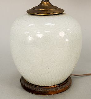 Celadon ovoid jar, the body covered in a soft green glaze and carved overall with floral decoration, mounted as...