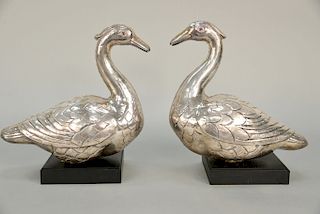 Pair of silver ducks with red glass eyes mounted on wood stands (weighted).  ht. 12 in., lg. 12 in.  Provenance: Property from a...