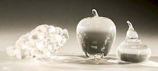 Group of three Steuben crystal ornaments signed Steuben to include a pear, apple, and grapes.  pear: ht. 3 1/2 in., apple: ht. 4 1...