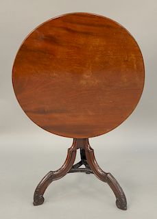 Mahogany Federal tip table with round top on shaft, ending in carved tripod base.  ht. 27 1/2 in., top: 27" x 27 1/2"