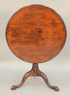 Chippendale mahogany tip and turn table having round dished top on birdcage, set on fluted and turned shaft, on tripod base with vin...