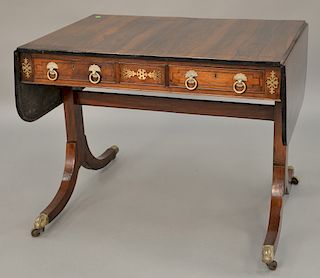 George III rosewood sofa table having drop leaves and brass inlays, set on four downswept members with brass ends.  ht. 28 in., to...