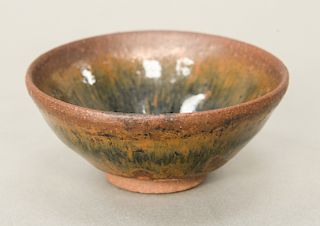 Hare’s fur stoneware (Jian Yao) tea bowl, China, the dark brown clay body covered with vertical striations.  dia. 3 3/4 in.