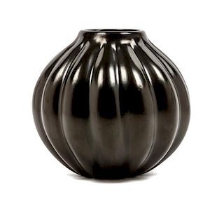 * A Santa Clara Blackware Pottery Vase Height 8 x diameter 8 inches.