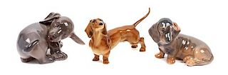 * A Group of Three Dachshund Porcelain Figures Width of widest 5 1/8 inches.