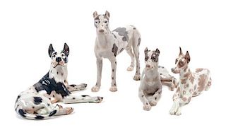 * A Group of Four Porcelain Great Dane Figures Height of tallest 10 1/2 inches.
