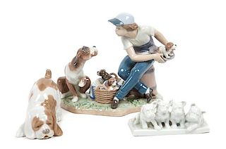 * Three Porcelain Dog Figures depicting Various Breeds Width of widest 8 1/2 inches.