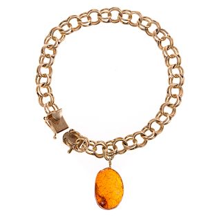 A Ladies Charm Bracelet with Amber Charm in 14K