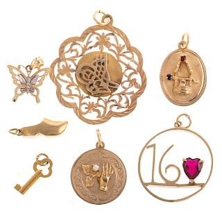 A Collection of 7 Charms & Pendants in Gold