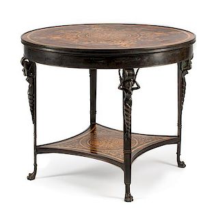 An Empire Style Patinated Bronze Table Height 29 x diameter of top 36 inches.