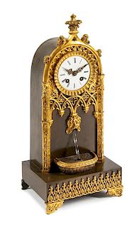 A Charles X Gilt and Patinated Bronze Fountain Clock Height 14 5/8 inches.