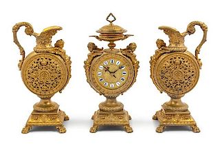 * A French Neoclassical Gilt Metal Clock Garniture Height of mantel clock 16 x width 7 x depth 4 1/2 inches.