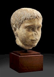 A Roman Marble Head of a Youth Height 8 inches.
