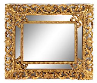 An Italian Rococo Style Giltwood Mirror Height 49 x width 57 inches.