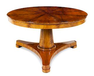 A Biedermeier Mahogany Center Table Height 29 x diameter of top 52 3/4 inches.