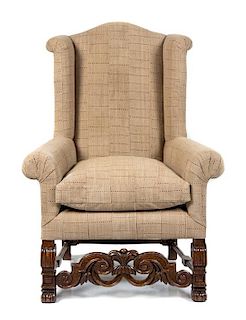 A Jacobean Style Oak Wingback Armchair Height 47 inches.
