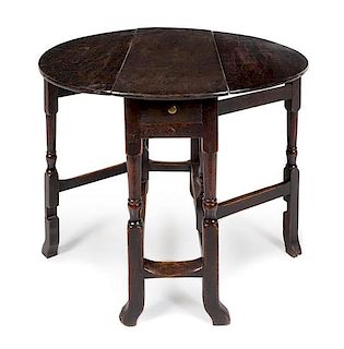 A William and Mary Oak Drop-Leaf Table Height 28 x width 34 x depth 12 1/2 inches.