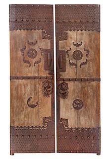 A Pair of Chinese Iron Mounted Hardwood Doors Height 111 x width of each 31 3/4 inches.
