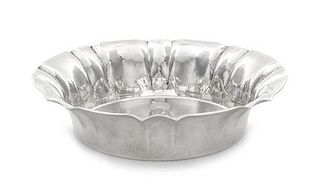 * A German Silver Centerpiece Bowl, Maker's Mark FL, Circa 1910, spot-hammered, with flared lobed sides