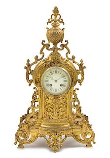 * A French Neoclassical Gilt Metal Mantel Clock Height 20 3/4 x width 11 1/2 x depth 4 inches.