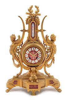 * A French Neoclassical Porcelain Mounted Gilt Metal Mantel Clock Height 19 x width 12 1/2 x depth 2 1/2 inches.