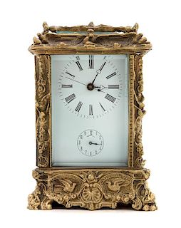 * A French Gilt Bronze Carriage Clock Height 6 3/4 x width 4 3/8 x depth 4 inches.