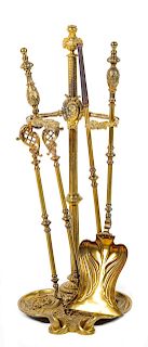 A Set of French Gilt Bronze Fireplace Tools Height of stand 29 5/8 inches.