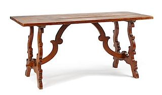 A Spanish Renaissance Style Walnut Trestle Table Height 30 1/2 x width 65 x depth 29 1/2 inches.
