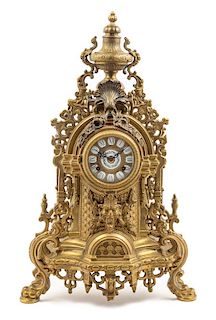 * A Continental Neoclassical Brass Mantel Clock Height 23 1/2 x width 14 1/2 x depth 4 1/4 inches.