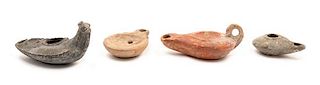 A Group of Four Roman Oil Lamps Height of largest 2 x width 4 inches.