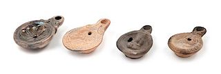 Three Roman Terra Cotta Oil Lamps Width of largest 3 1/2 inches.
