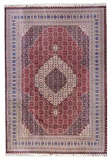 A Tabriz Wool Rug 12 feet 2 inches x 8 feet 11 inches.