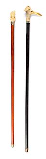 Two Continental Carved Figural Walking Sticks Length of longer 36 inches.